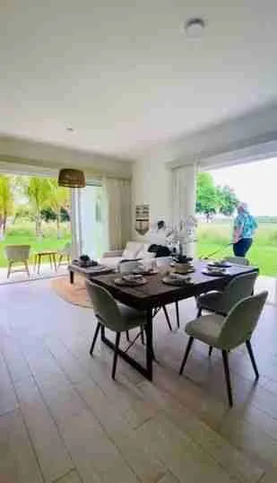 Panorama views of the golf course and pool from this corner apartment for sale at Punta Cana 1
