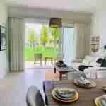 Panorama views of the golf course and pool from this corner apartment for sale at Punta Cana 2