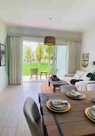 Panorama views of the golf course and pool from this corner apartment for sale at Punta Cana 2