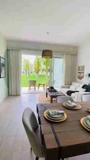Panorama views of the golf course and pool from this corner apartment for sale at Punta Cana 2