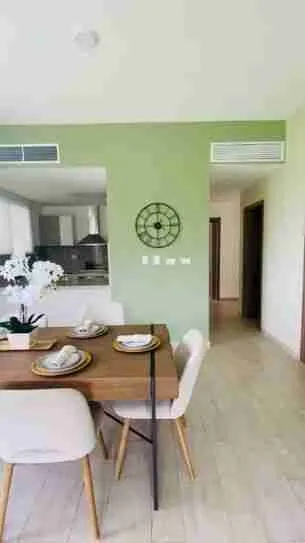 Panorama views of the golf course and pool from this corner apartment for sale at Punta Cana 3
