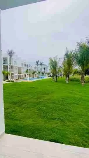 Panorama views of the golf course and pool from this corner apartment for sale at Punta Cana 4