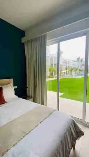 Panorama views of the golf course and pool from this corner apartment for sale at Punta Cana 6