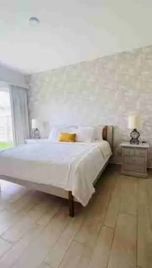 Panorama views of the golf course and pool from this corner apartment for sale at Punta Cana 9