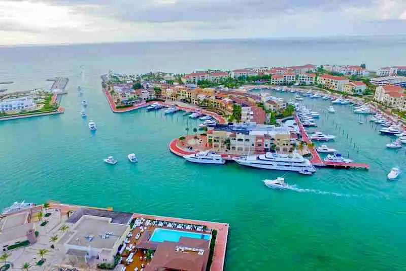 Aerial view of Cap Cana, Dominican Republic, showing the luxury marina, turquoise coastline, Punta Espada golf course, and exclusive real estate.