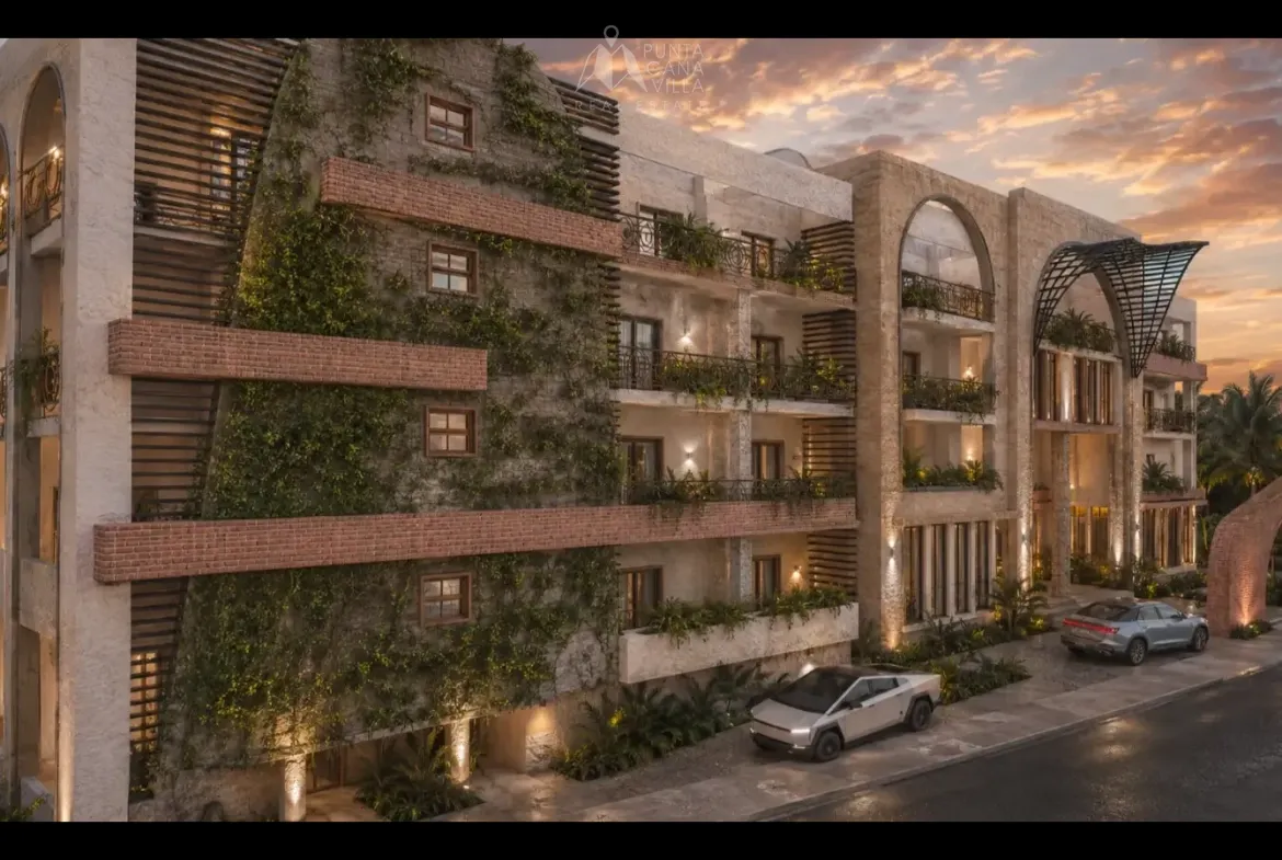 Exterior view of the Belara Cap Cana apartment building with lush landscaping